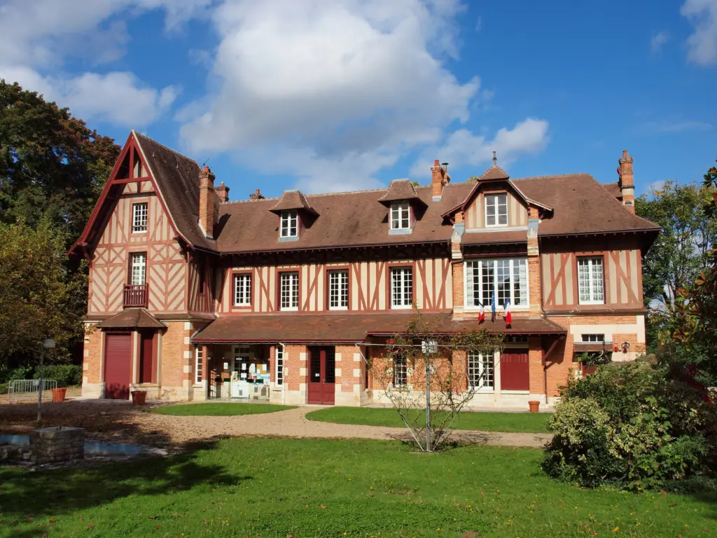 La mairie de Saint-Hilaire-Saint-Mesmin, une maison à colombages et briques au milieu d’une pelouse.